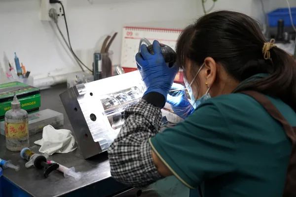 Manual Mold Fitting Technician manually fitting and finishing a mold component