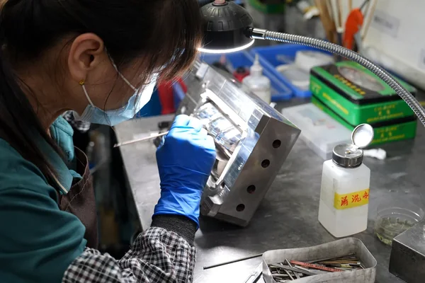 Mold Polishing and Assembly Technician polishing and assembling an injection mold